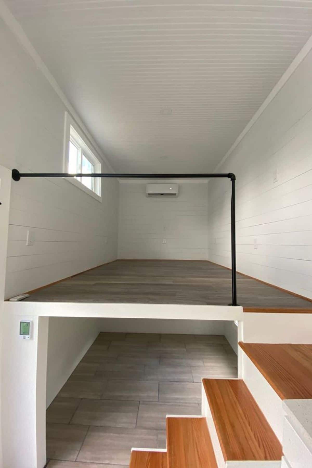 open loft above crawl space with black railing