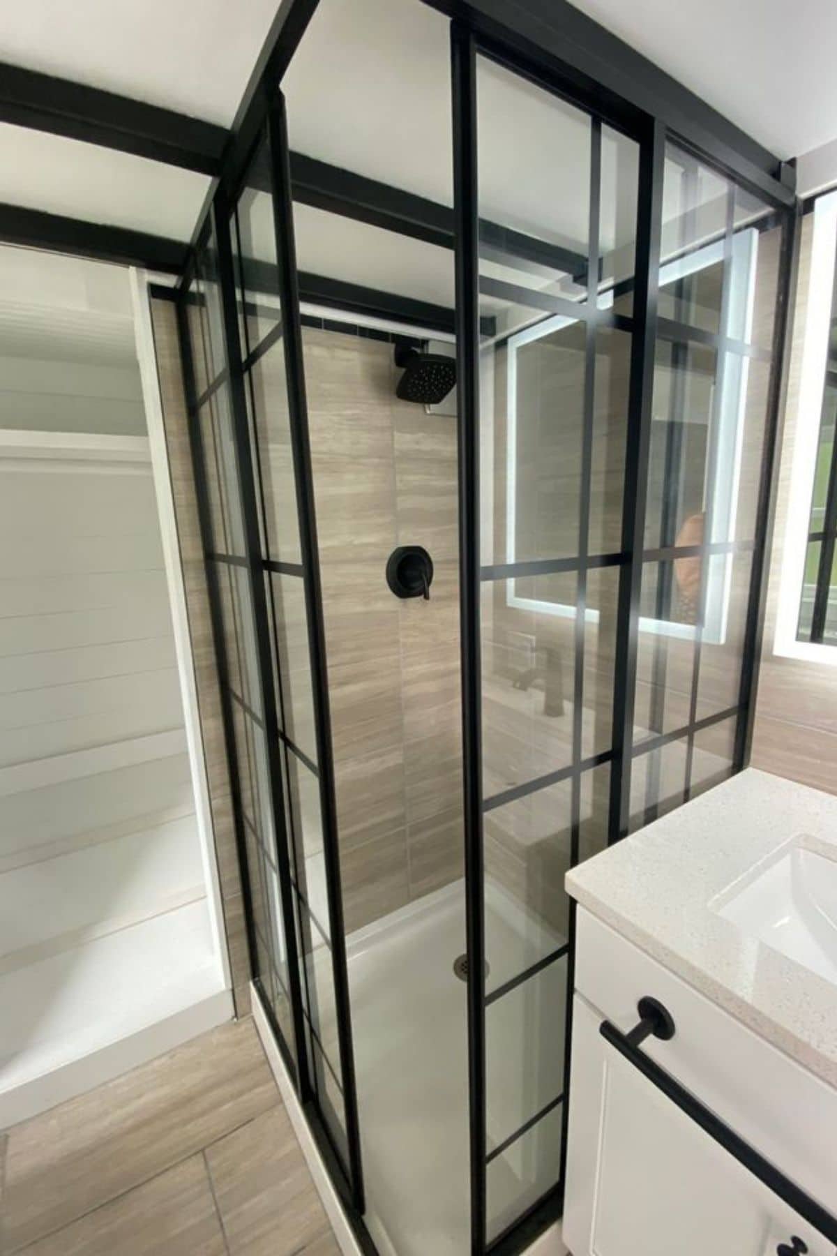 corner square shower with black trim on glass panels