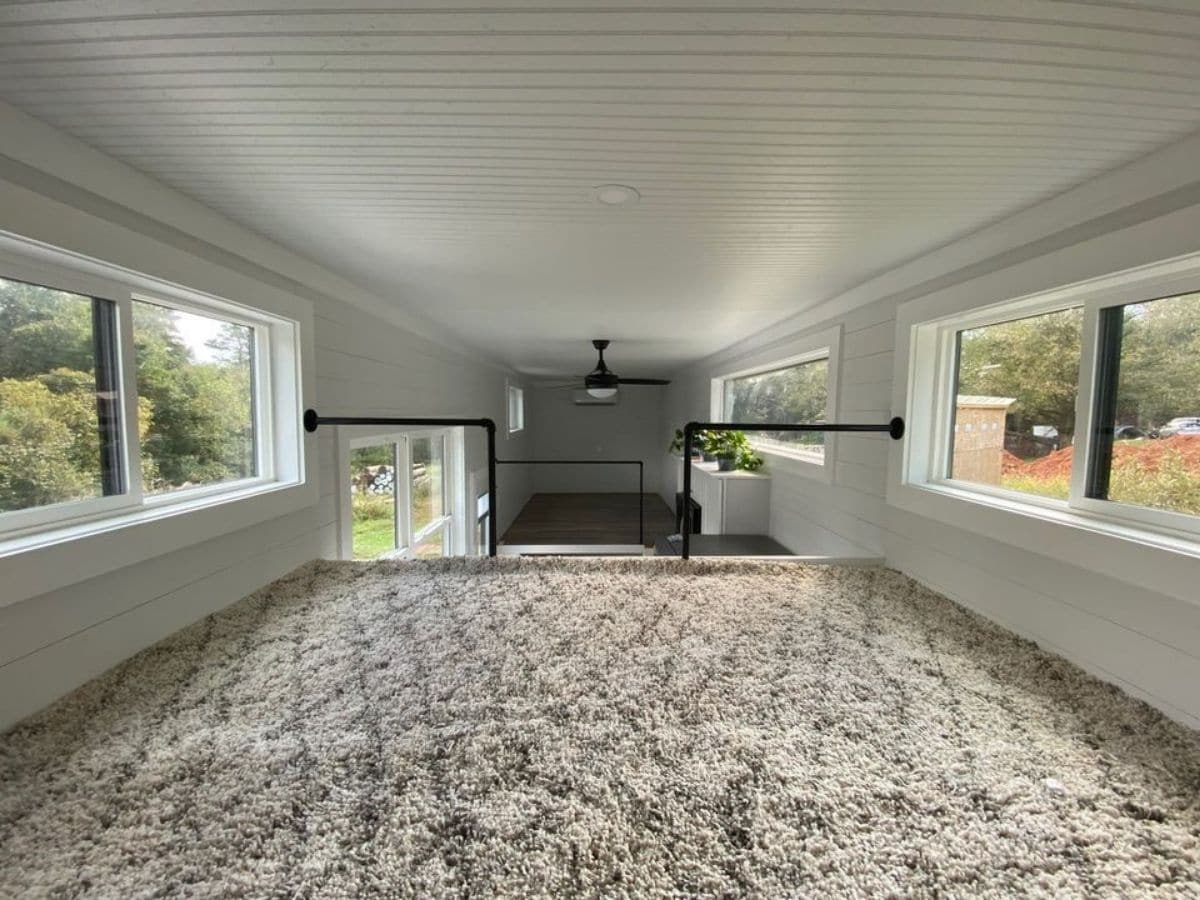 carpeted loft view across top of home