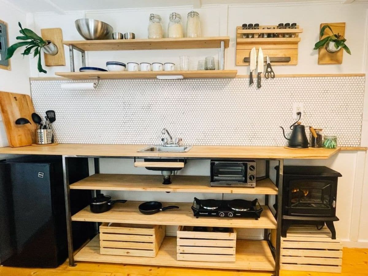 wood open shelves with wood baskets on bottom in kitchen
