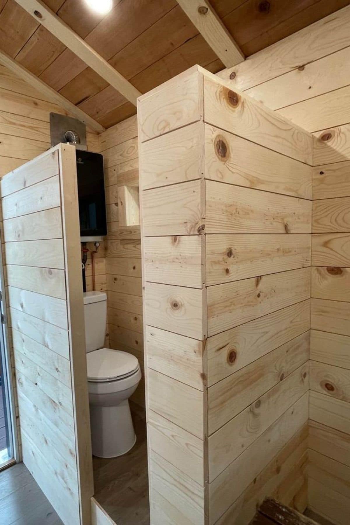 light wood walls around toilet in tiny home