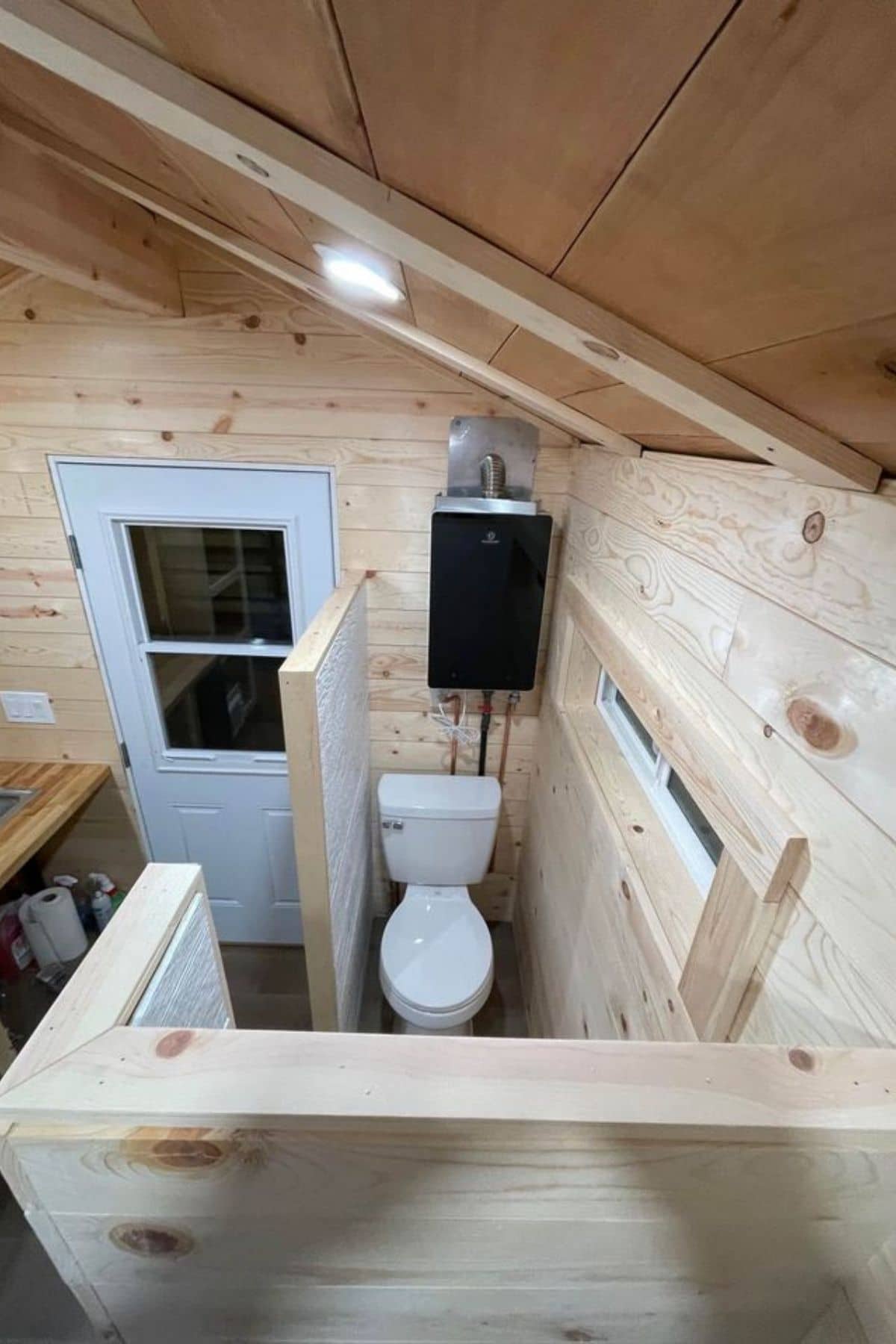 view from loft down into bathroom with white flush toilet
