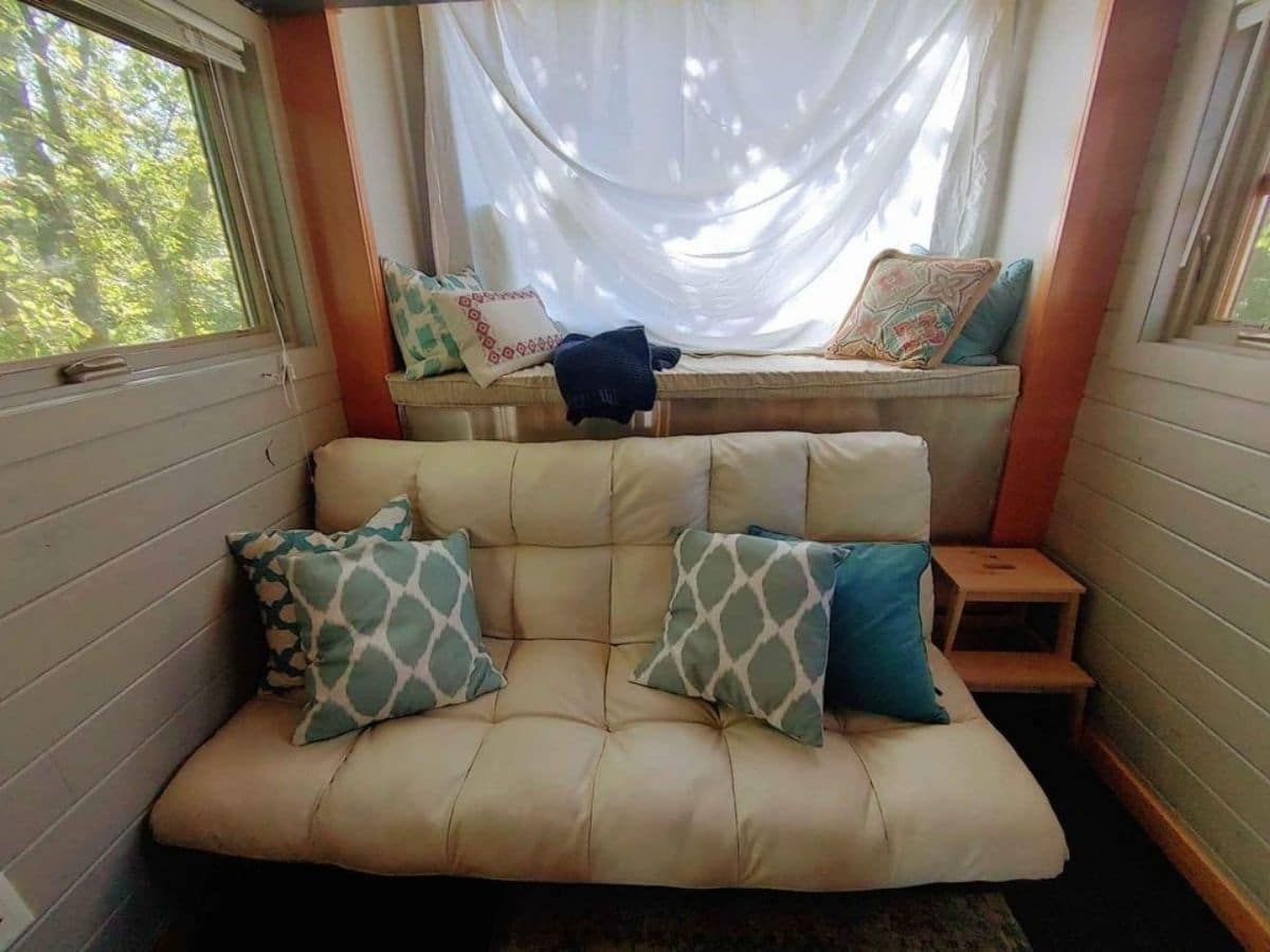 cream colored futon in front of picture window