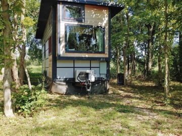 tiny home with large window on end and light brown siding