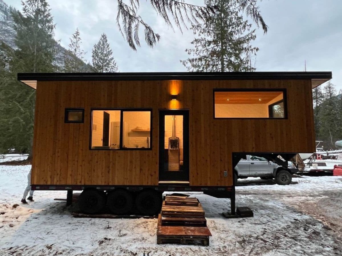 wood tiny home against snowy background