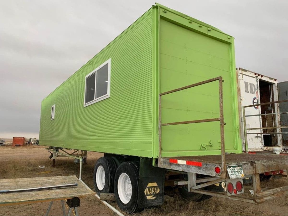 shipping container home painted bright green