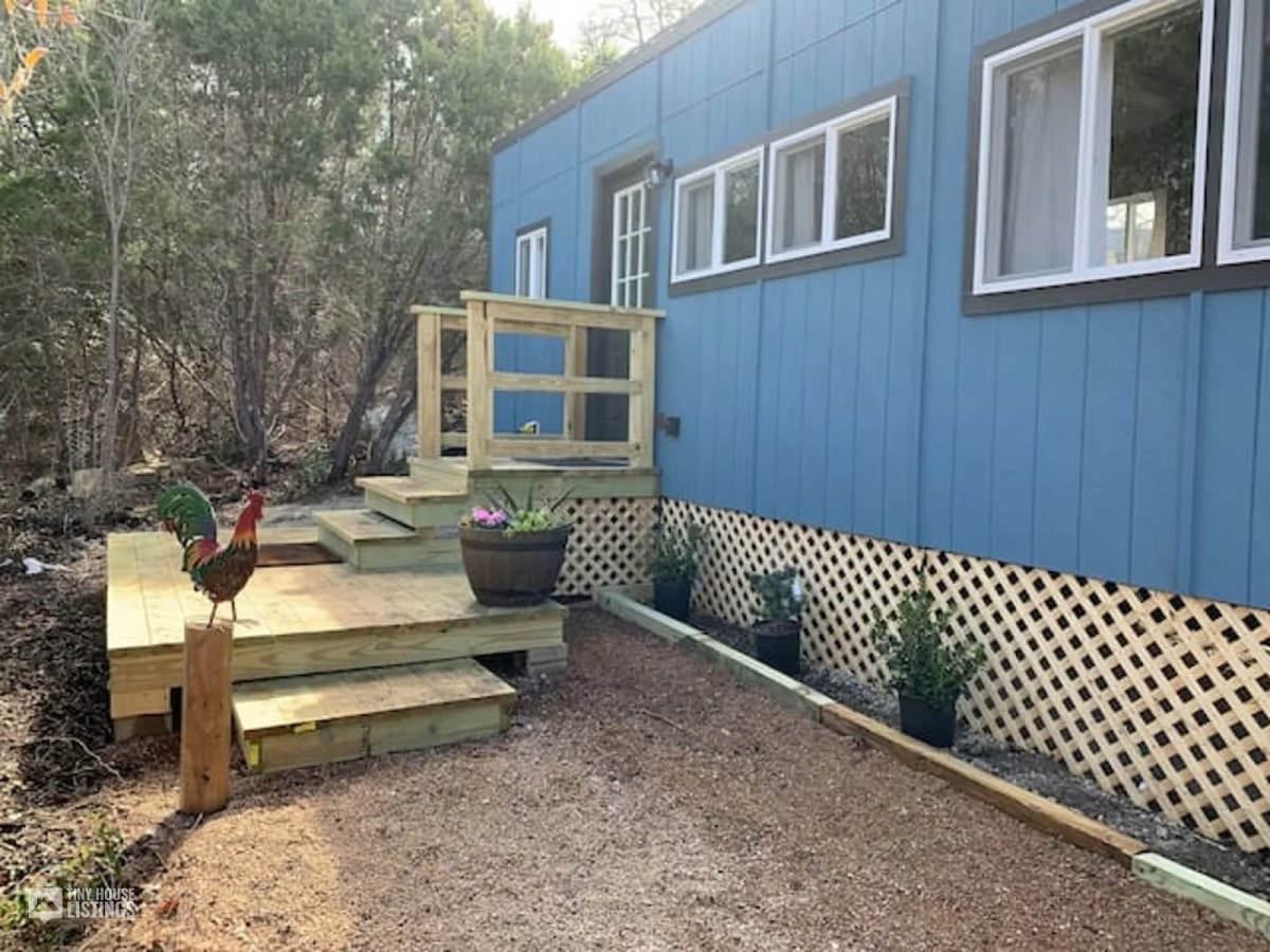 Blue tiny house with open walkway
