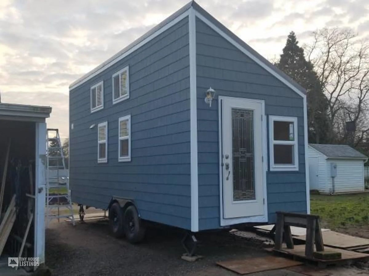 Blue with white accents tiny house on wheels