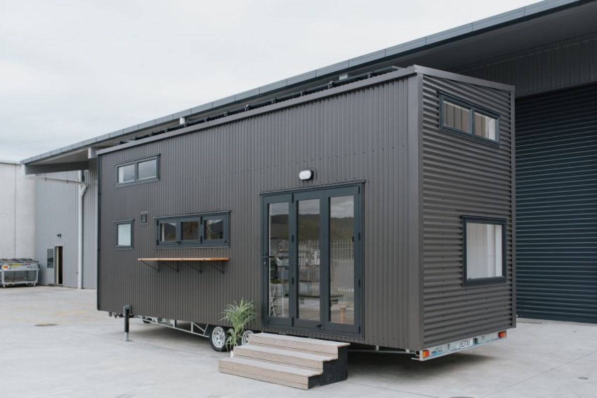 Black Cointainer style tiny house with wheels