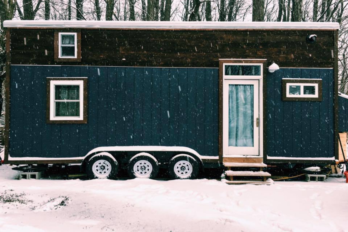 Blue mobile home with wheels on the snow