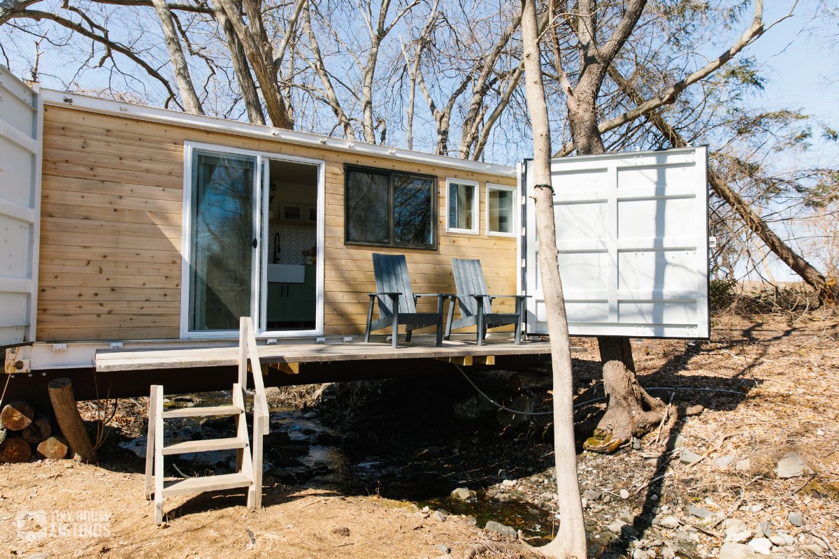 Tiny home perched up on a stream of water