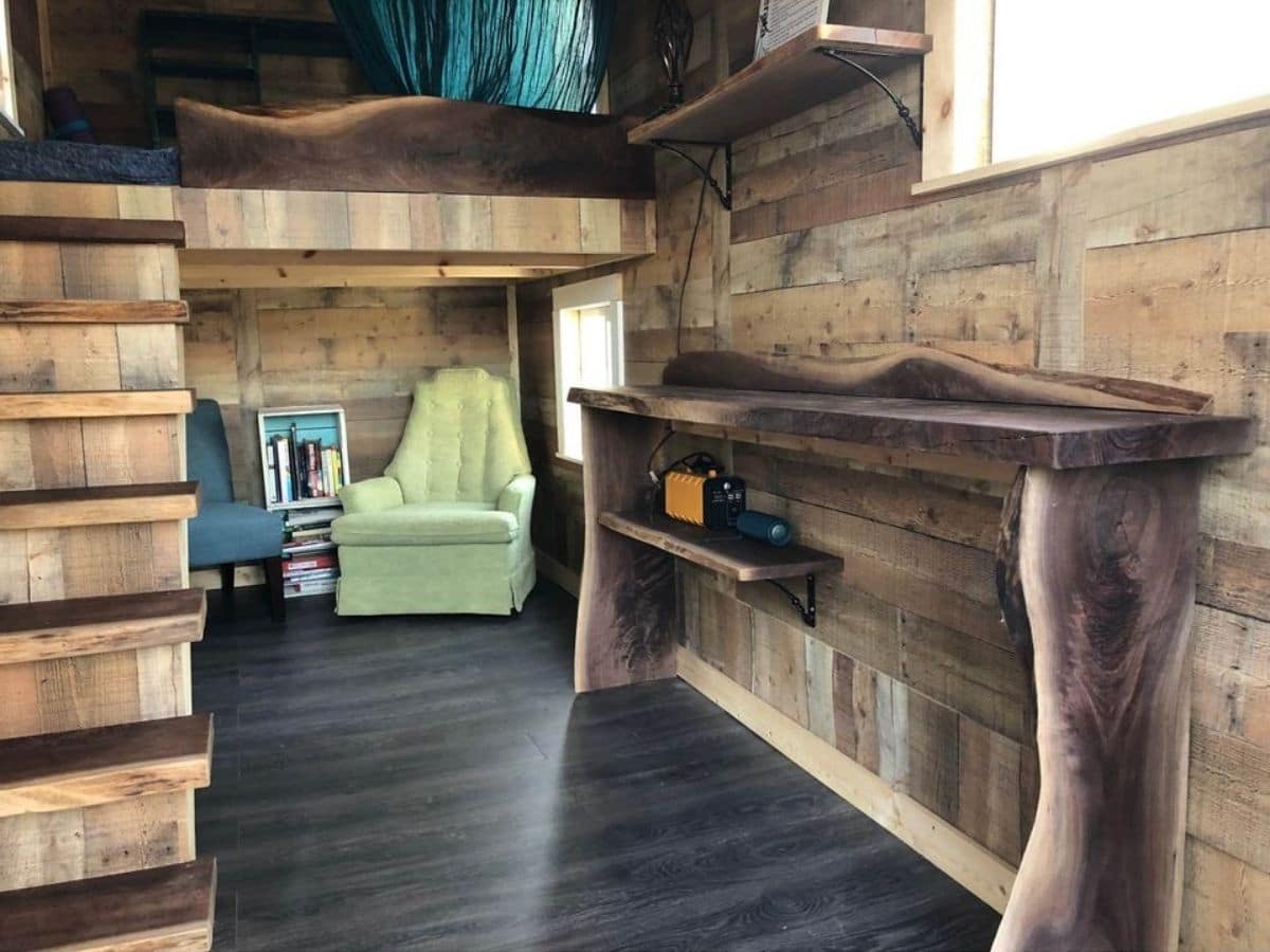 wooden bench against wall of tiny home