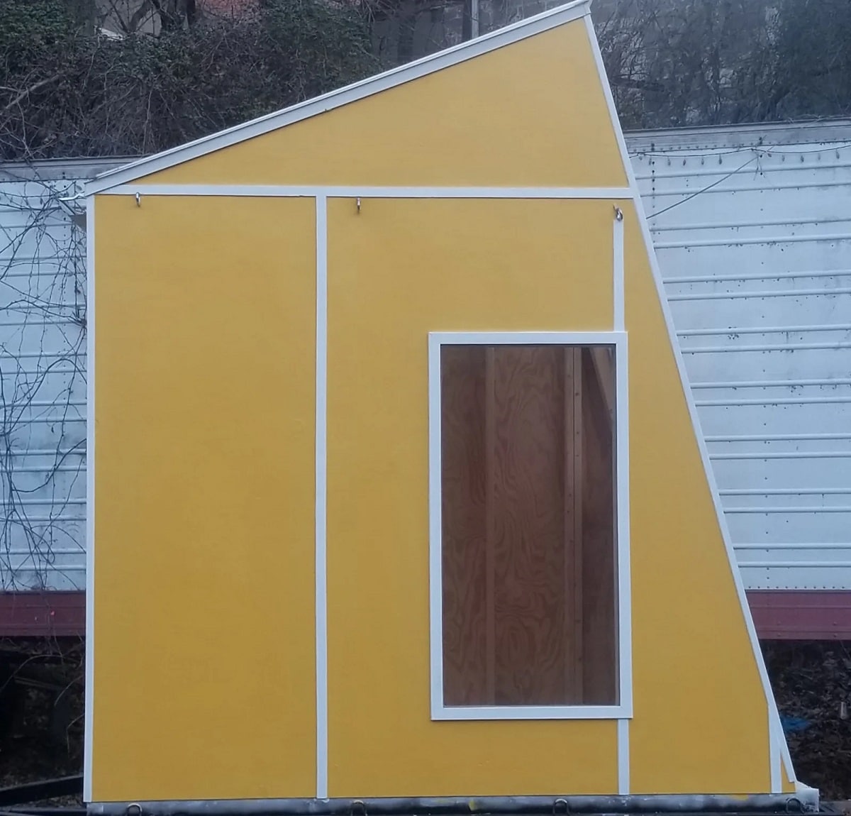 Yellow tiny house with skylight