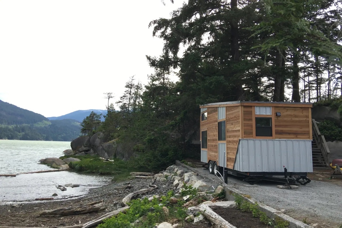 Prefab tiny house parked infront of lake