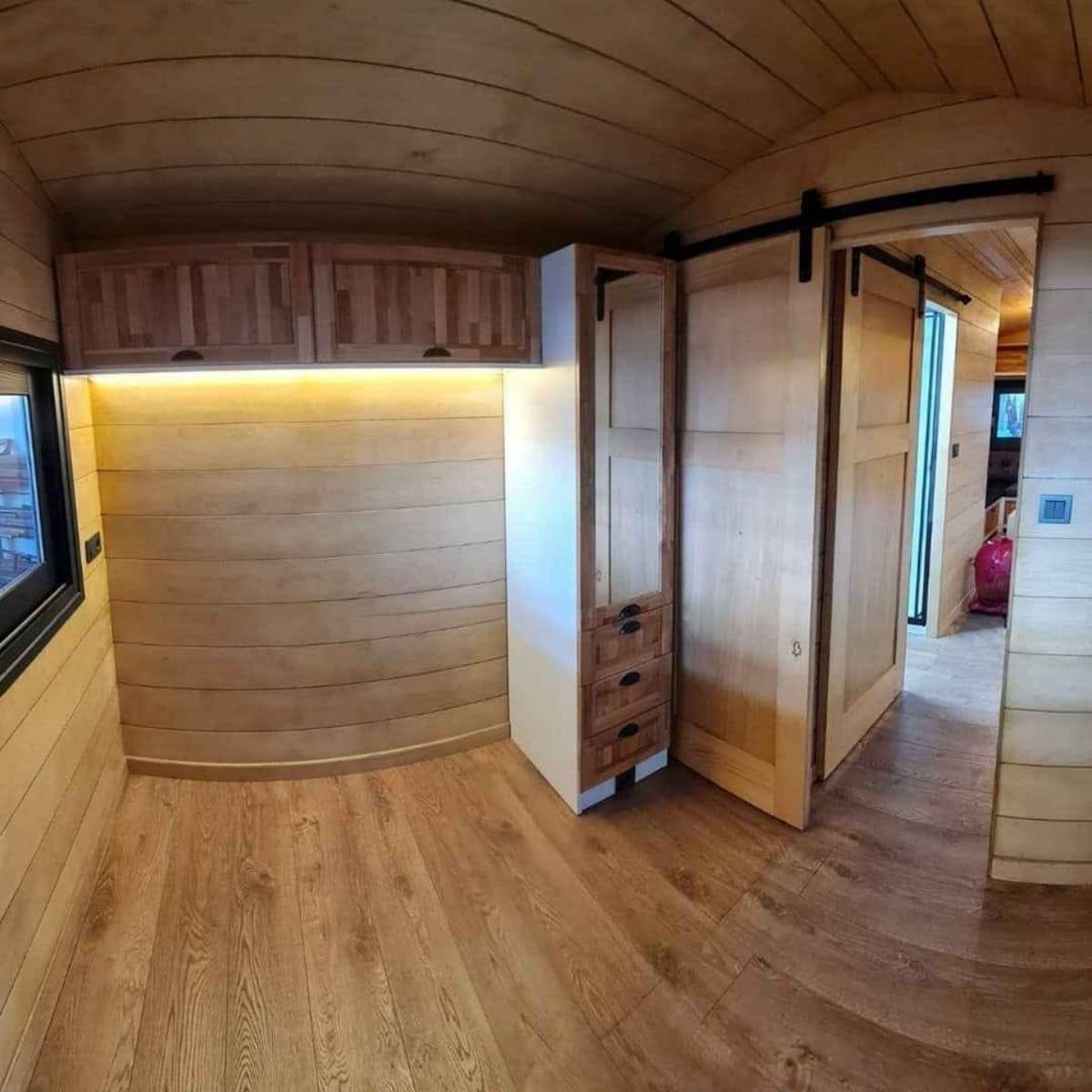 empty bedroom with wood walls in tiny home