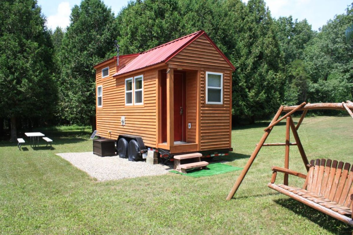 tiny log cabin with door awning and red rooftiny log cabin with door awning and red roof