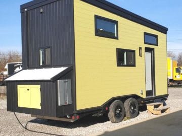 lime green and black tiny home with small storage at back of home