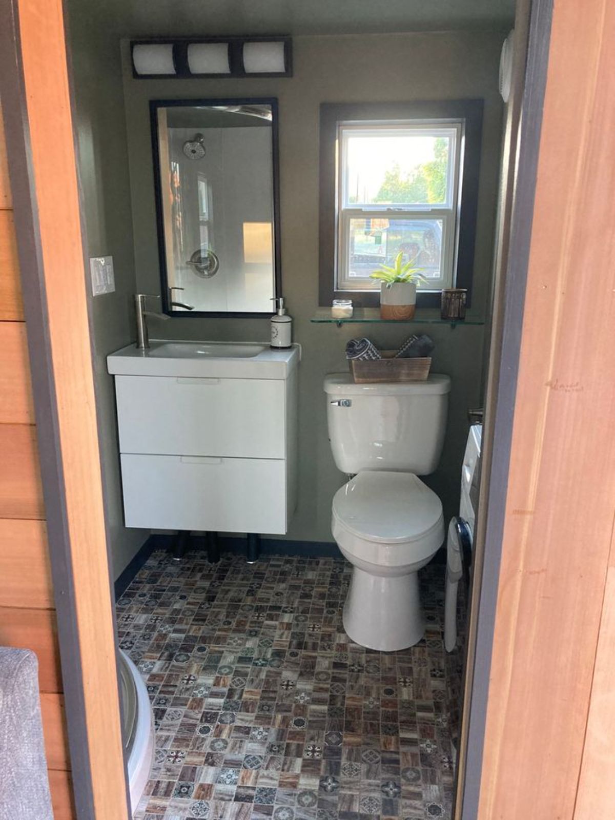 white toilet and vnaity in bathroom with tiled floors