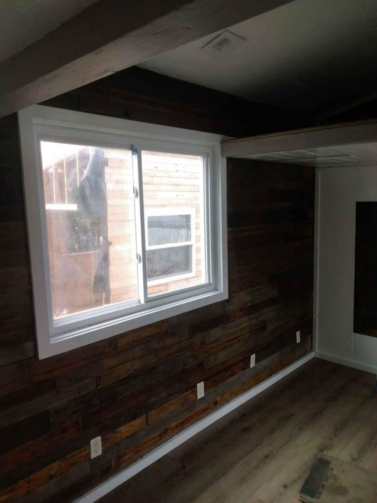 reclaimed wood wall around white trimmed windows