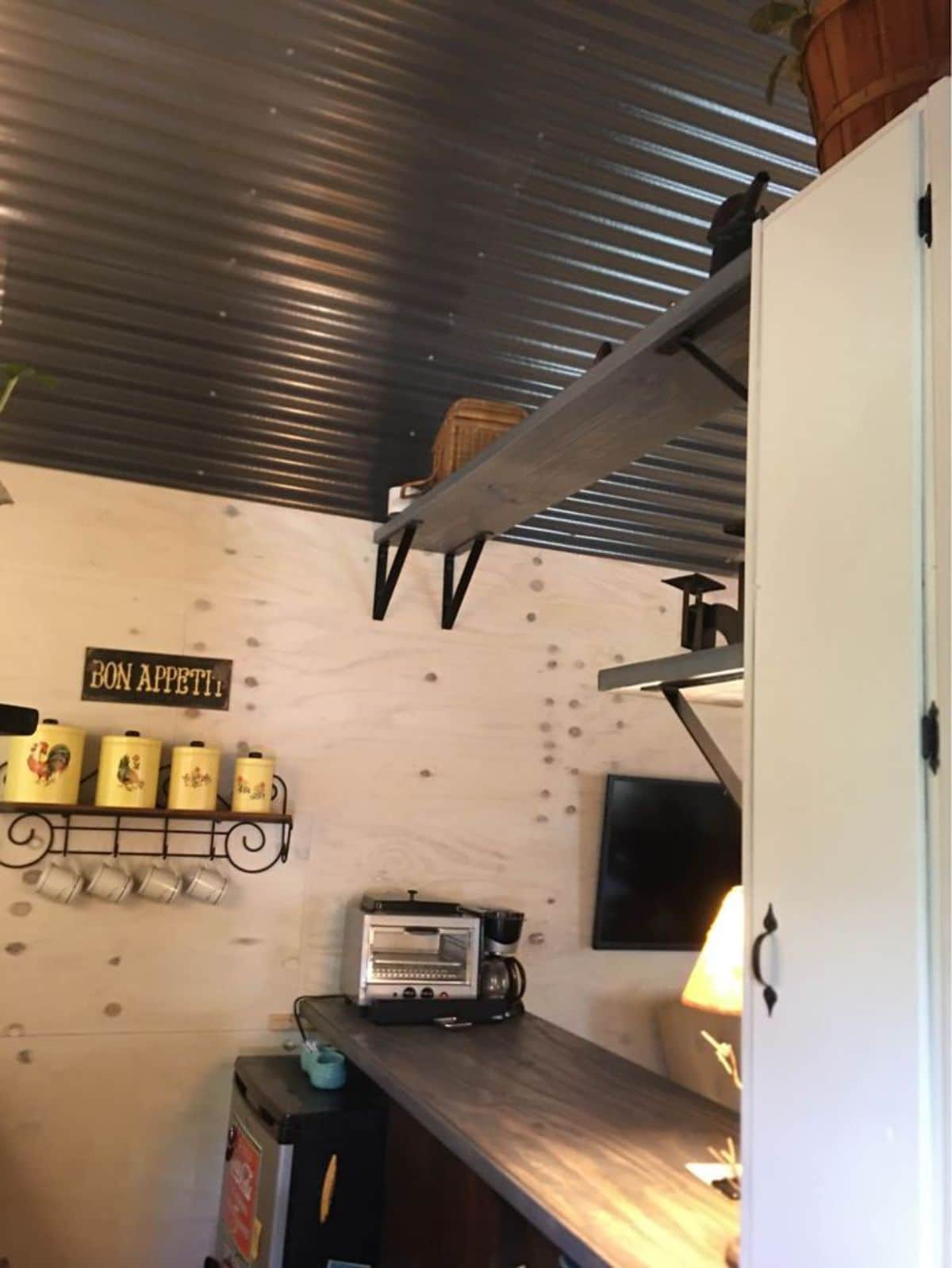 metal ceiling above kitchen with wall shelves