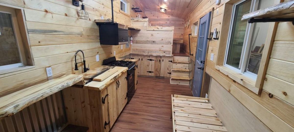 inside log cabin with pine cabinets and black appliances