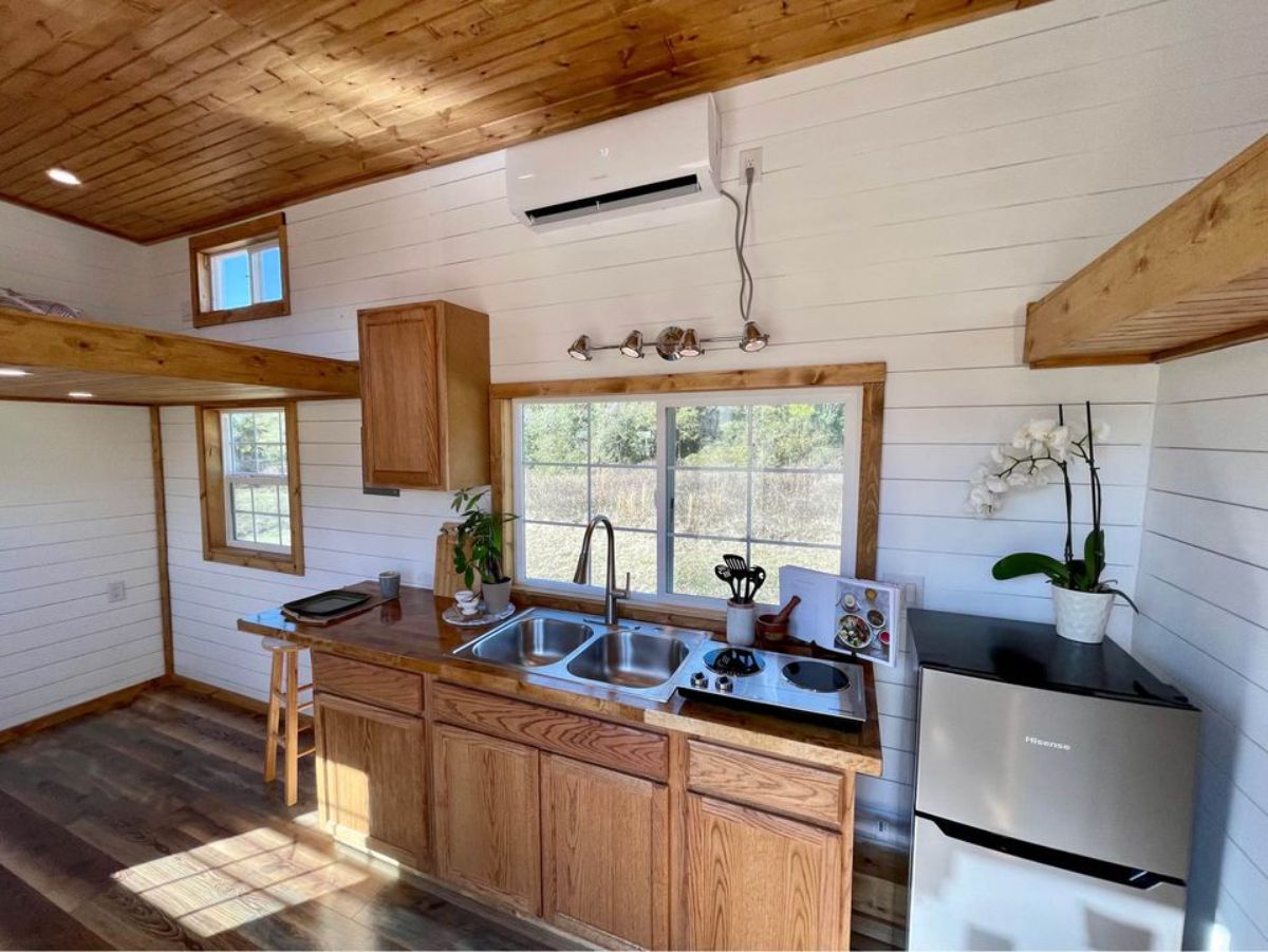 kitchen with wooden interiors in a tiny home on wheels
