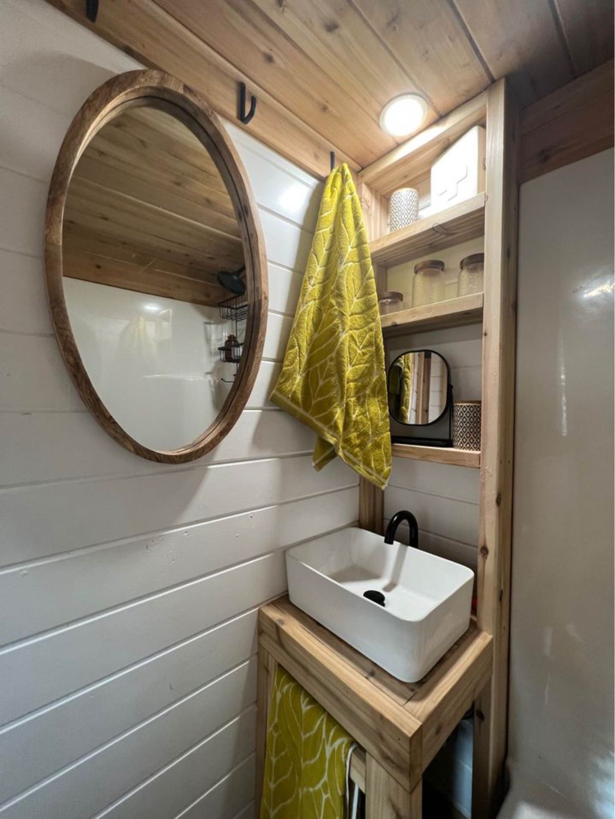 a sink on the side with cabinets below to store all your toiletries