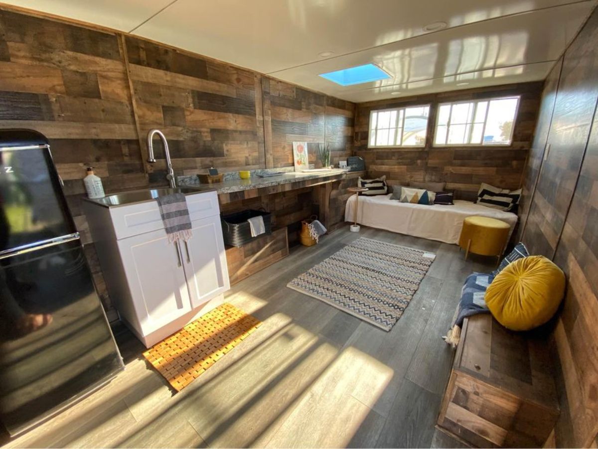 Wooden Interiors, open kitchen and sitting space of 18' Workspace on Wheels