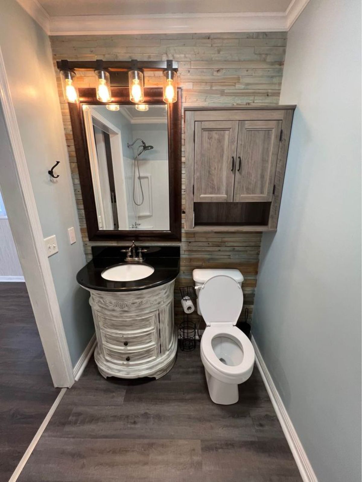 Toilet and sink of 1 Bedroom Barn-Style Tiny House