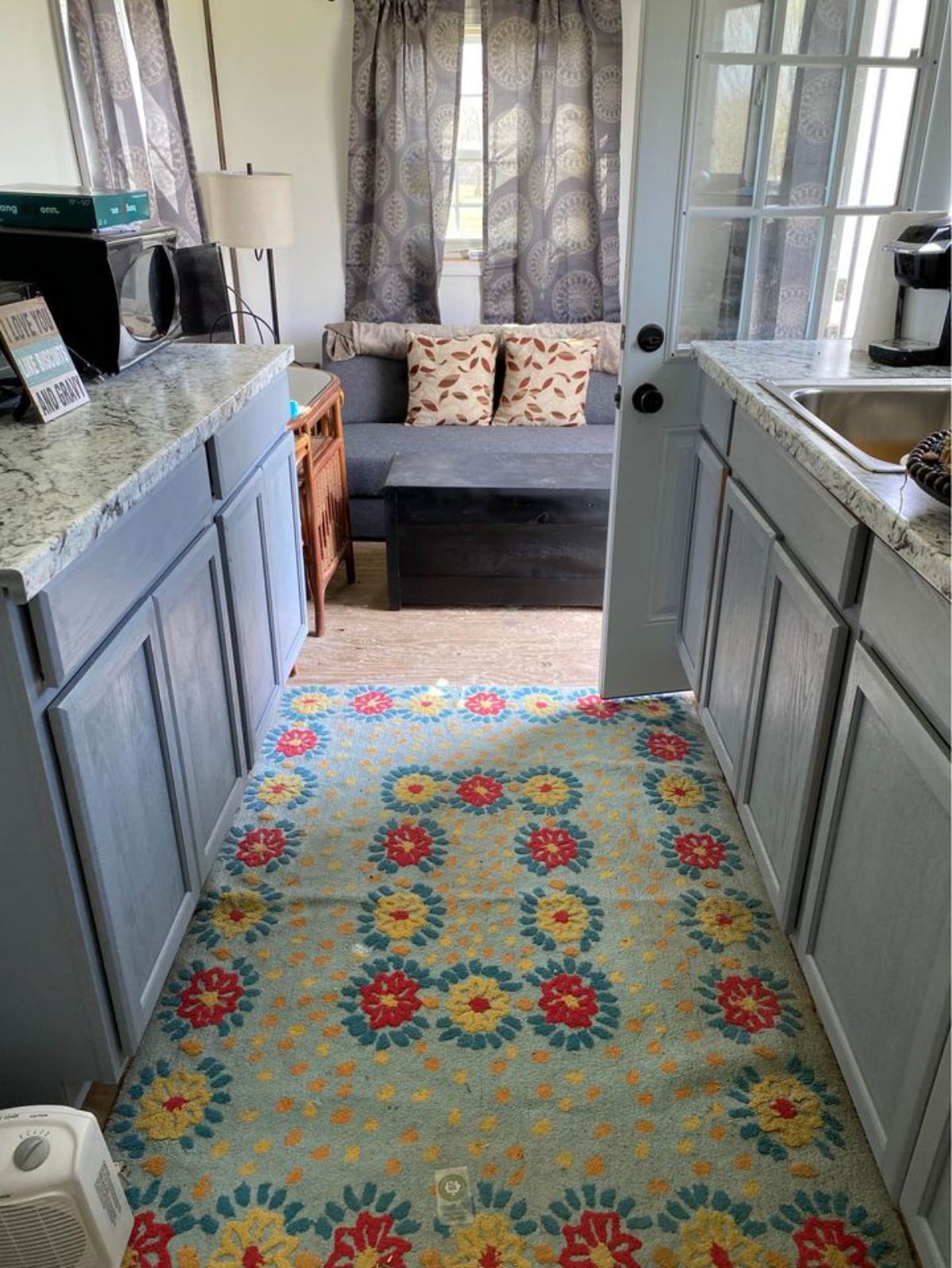 Living area has carpet on floor of 20’ Tiny House on Trailer