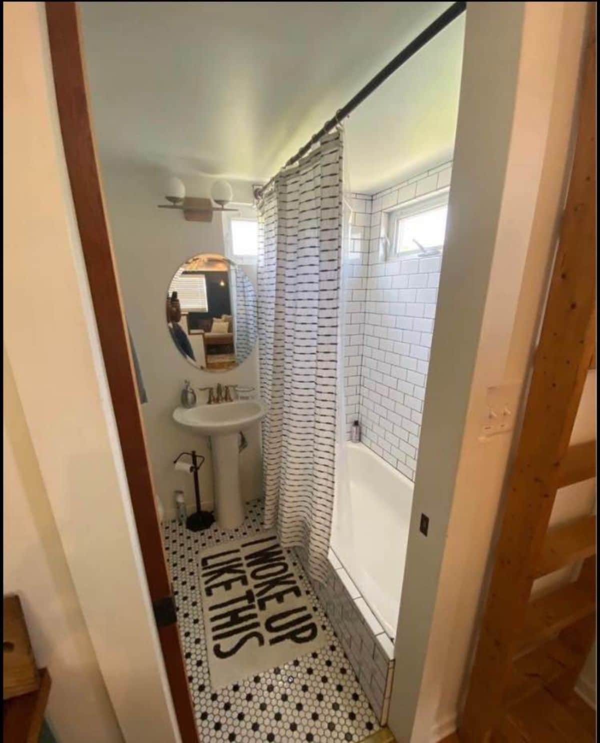 Well organized and a compact bathroom with sink toilet and a bath tub