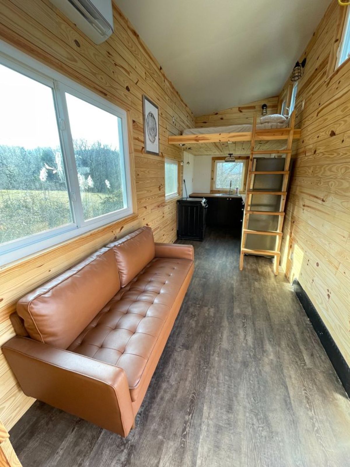 Living area of 24’ Tiny House on Wheels has a couch