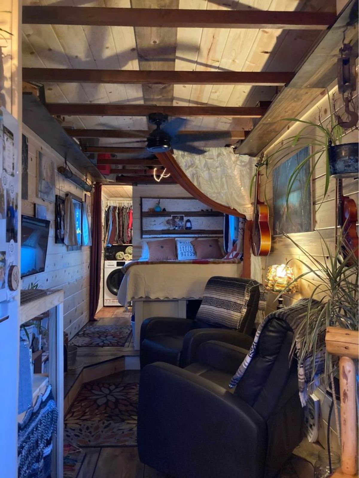Living area of 240 sf Tiny House has a recliner and a television set