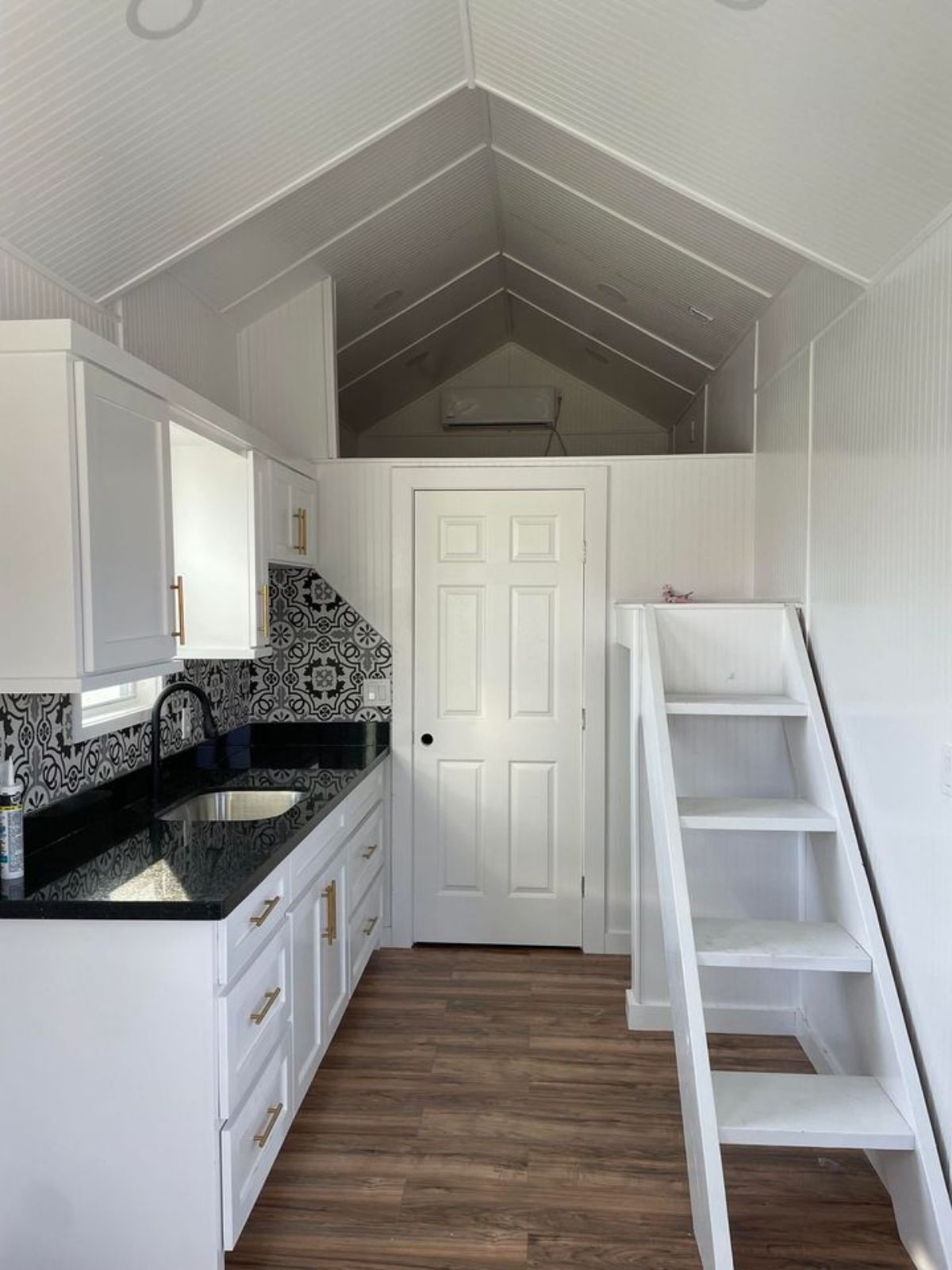 Ladder towards bedroom of 29' Long Luxury Tiny Home On Wheels