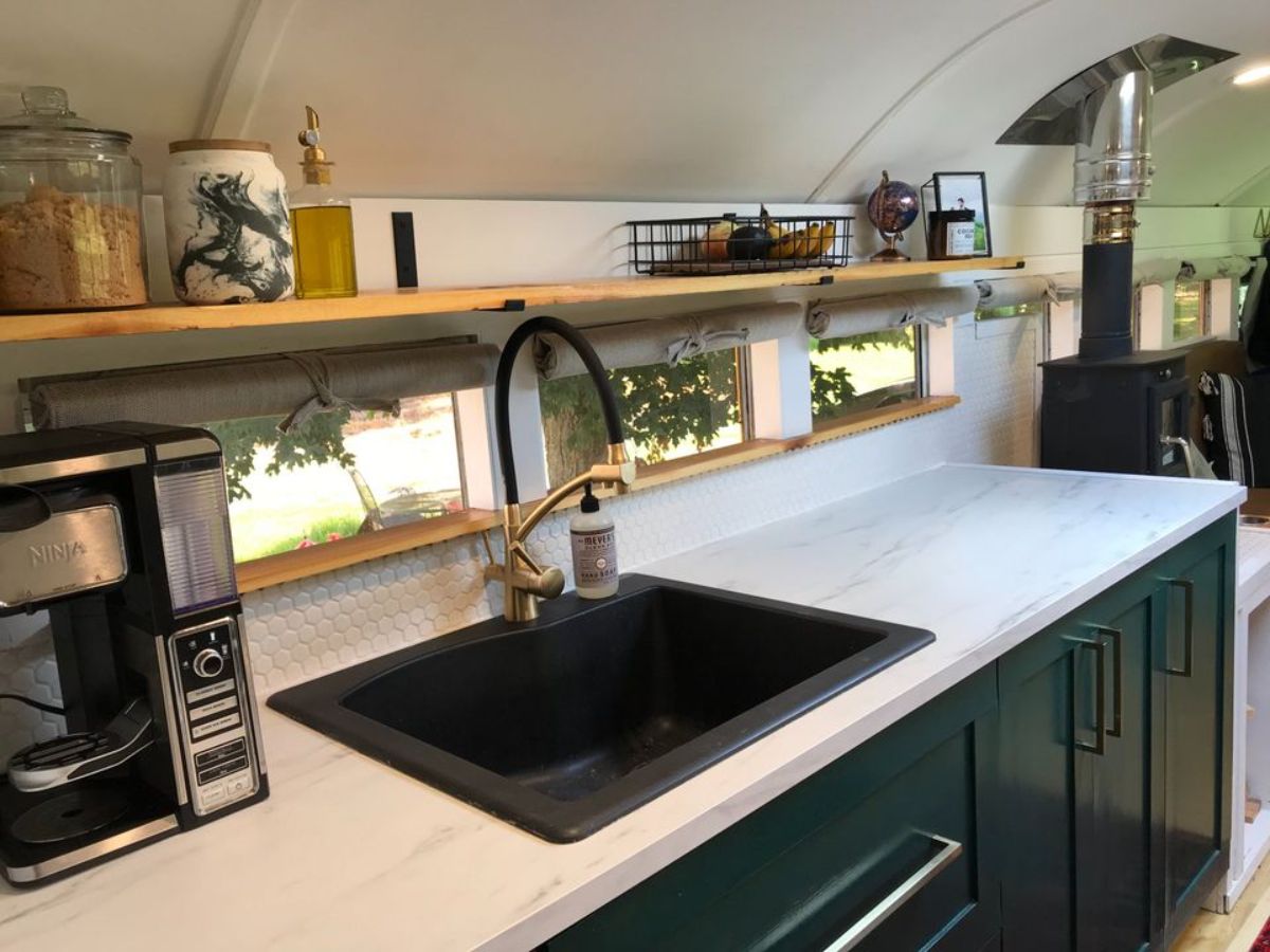Large black sink and counter top in kitchen of 37’ Converted School Bus