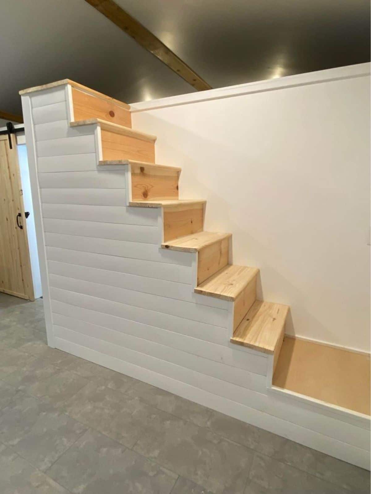 One loft is accessible through stairs and another opposite is accessible through ladder