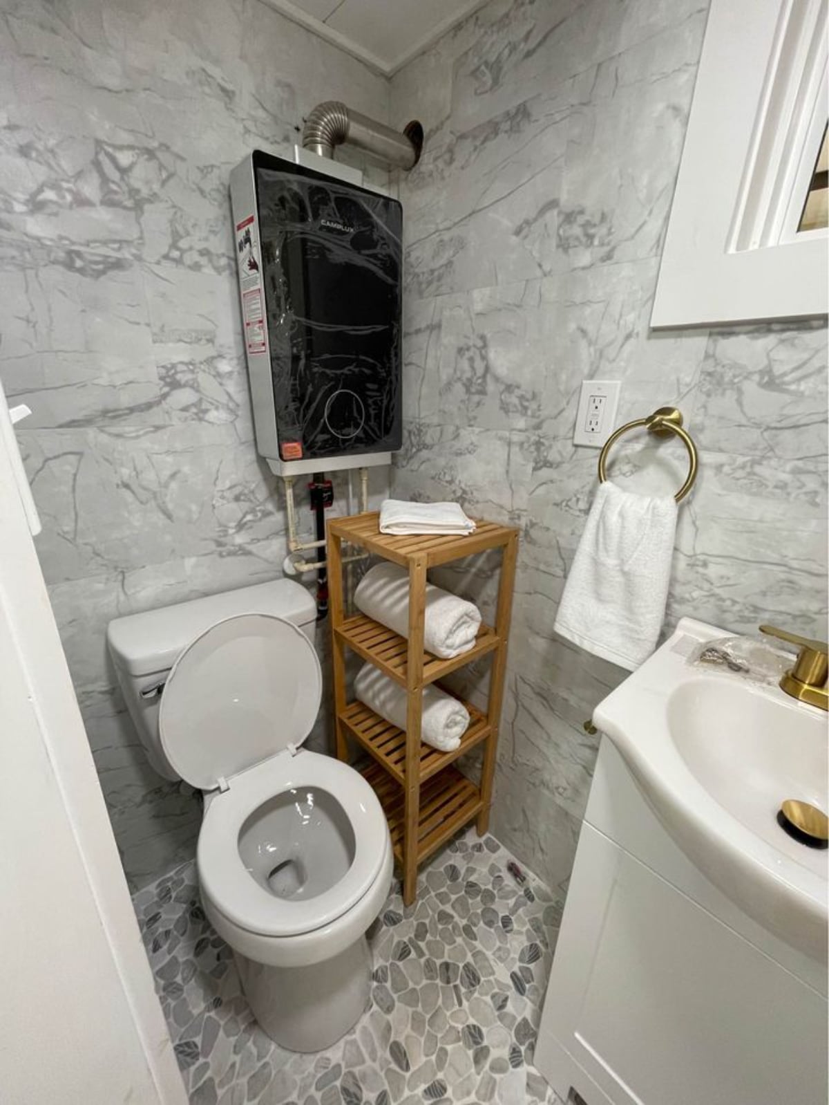 Compact yet stylish white interior bathroom toilet of 16' Compact Tiny House