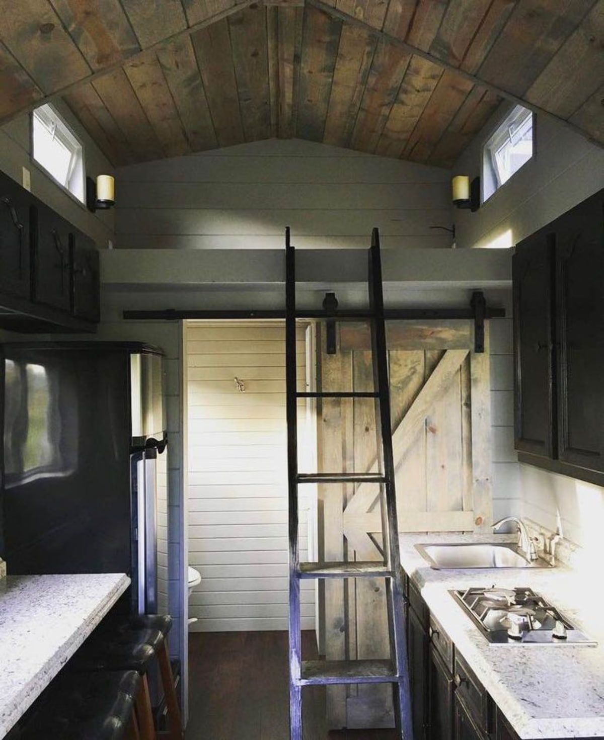 Ladder towards the loft bedroom of 180 sf Adorable Tiny House on Wheels