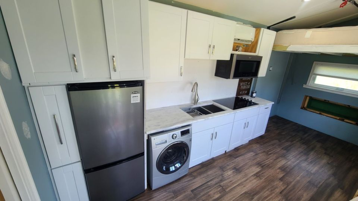 Kitchen of 24' Tiny Home has steel faucet, dishwasher, washer/dryer combo , refrigerator stove and sink