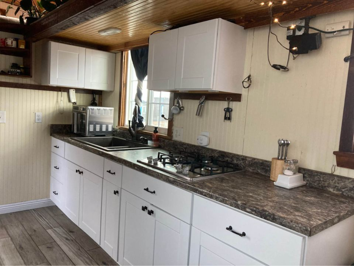Kitchen area of 30' Budget-Friendly Tiny House is decently spaced with kitchen equipment's