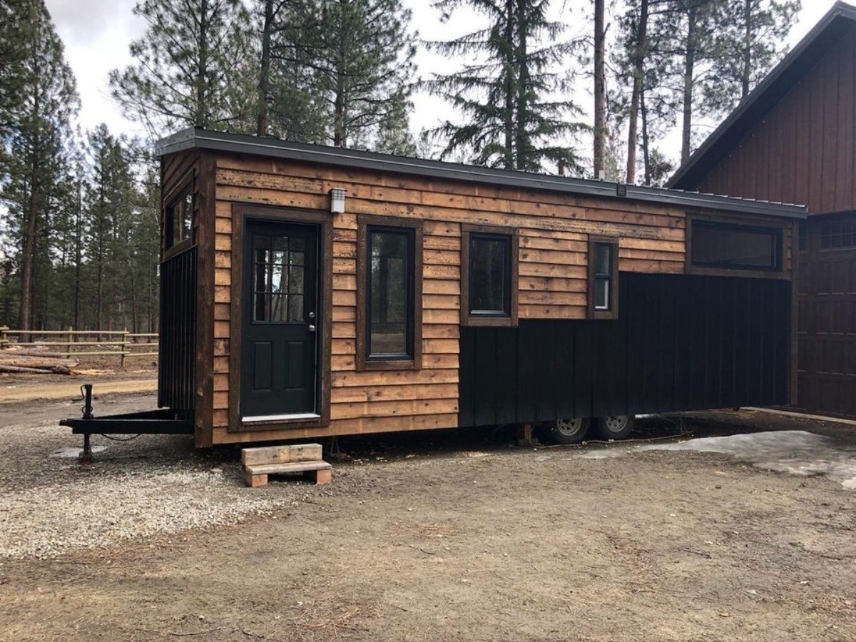 Front entrance door view of 30’ Tiny House on Wheels from outside