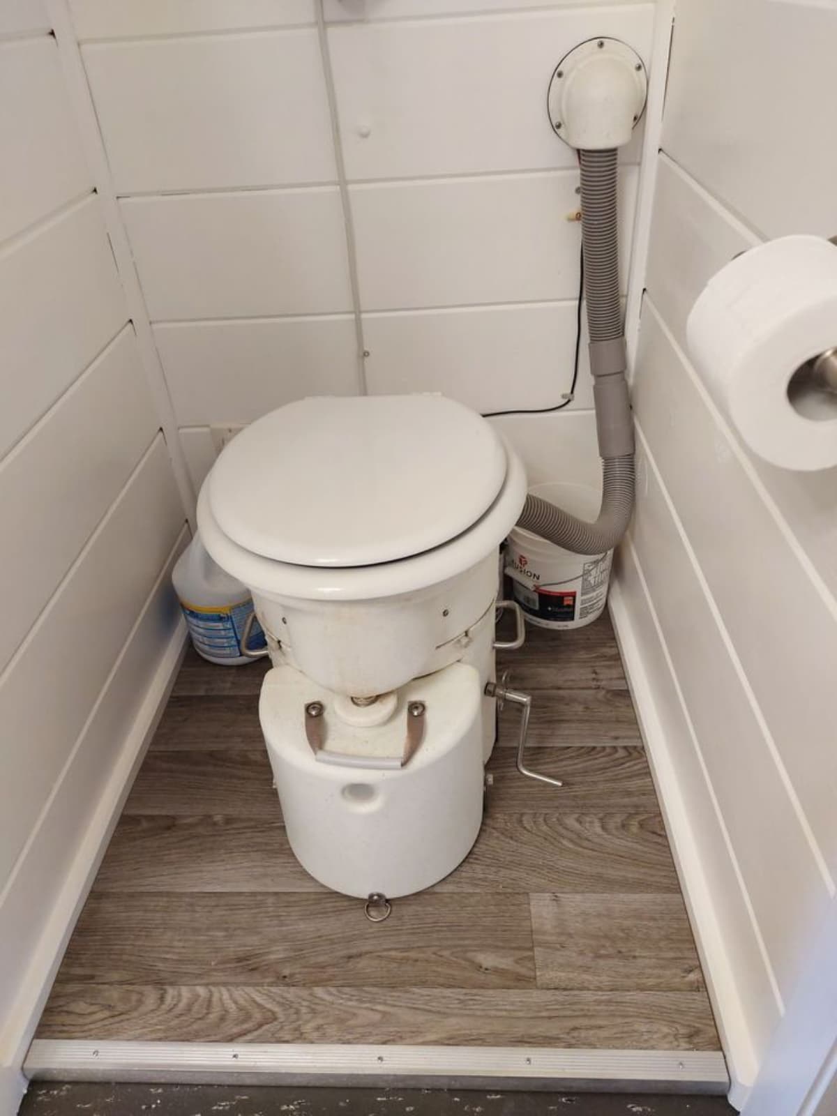 Standard toilet in bathroom of 40' Shipping Container Tiny House