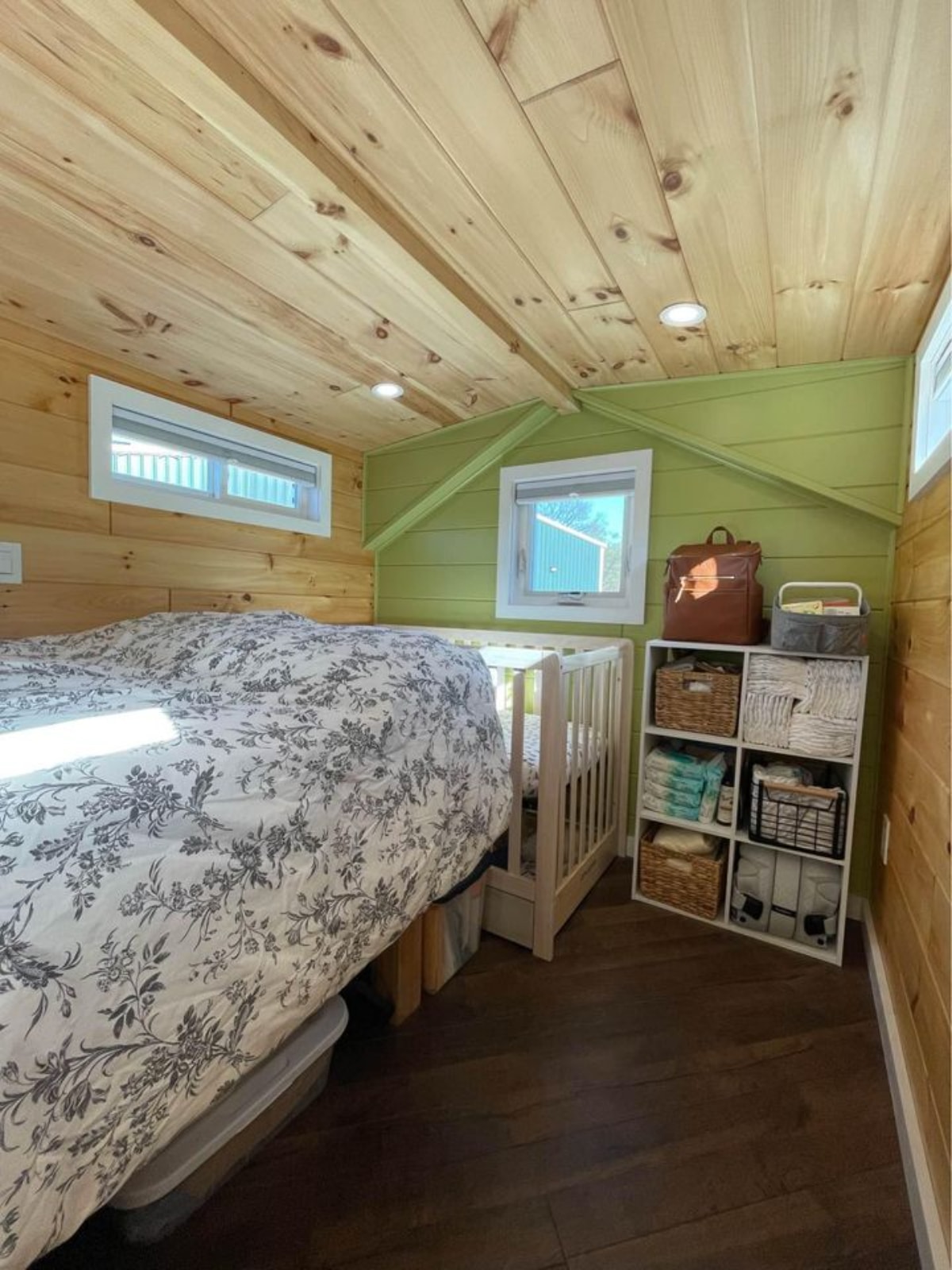 Loft bedroom of 40' Tiny House has comfortable queen bed, a crib, small rack for clothes and few stuffs