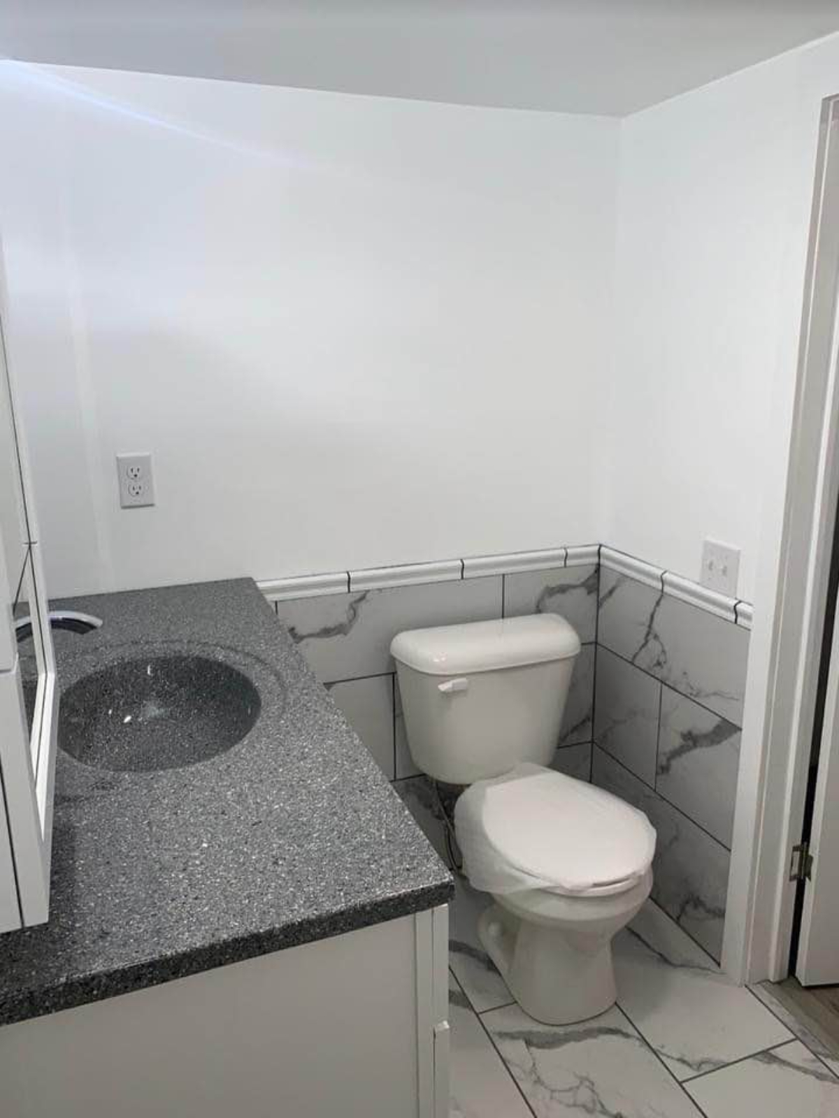 Standard toilet and sink of 400 sf Fireproof Tiny House 