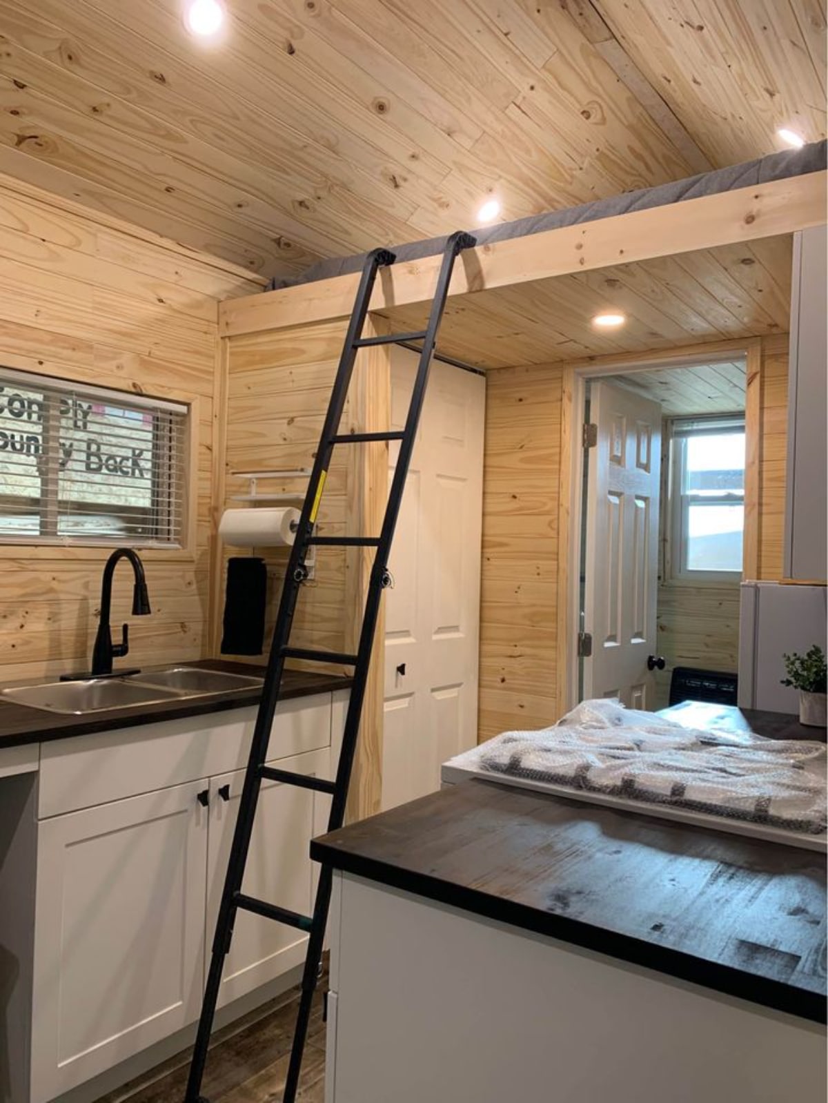 Ladder towards the loft bedroom of Cozy Four Season Tiny House