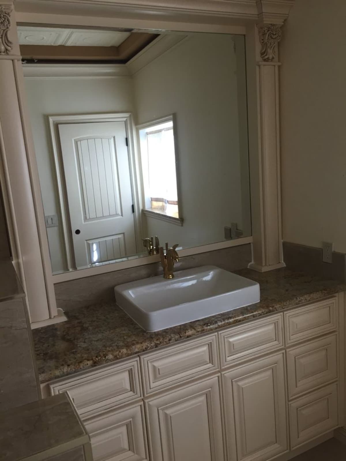 Sink with mirror and vanity in bathroom of Custom 48’ Artistic Tiny House