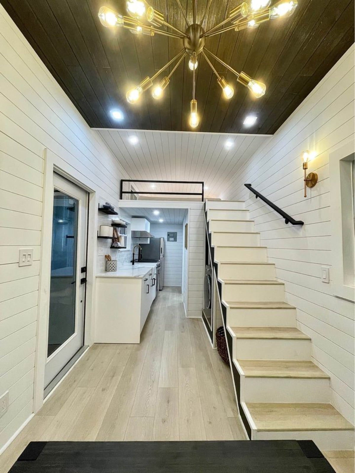 Kitchen area and stairs towards the bedroom of New 24' Luxury Tiny Home