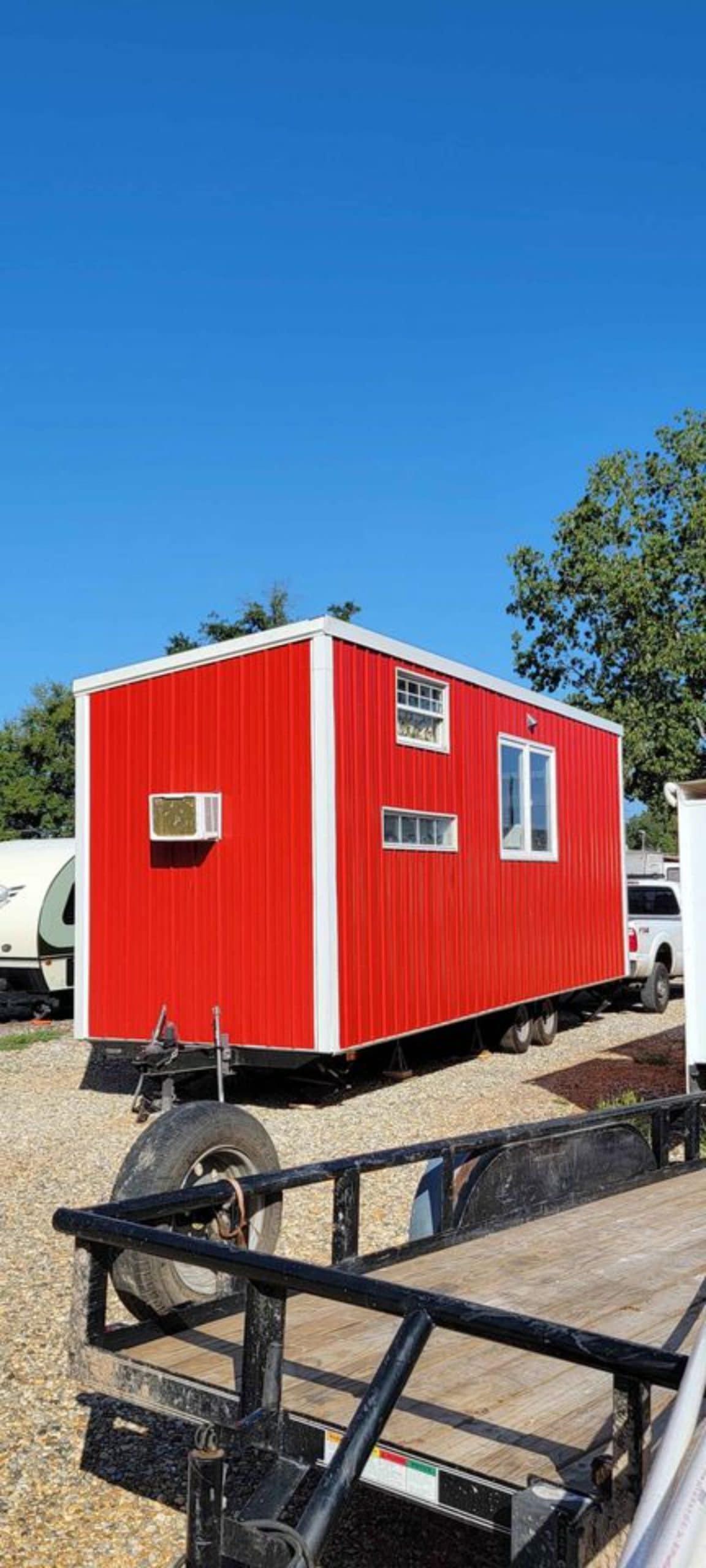 Stunning red exterior of 28' Budget Friendly Tiny House Has Two Lofts