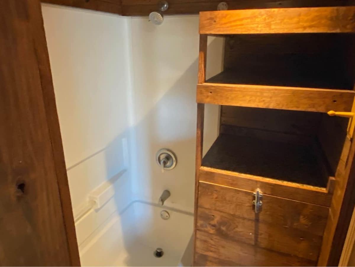 Separate shower area with lots of wooden storage