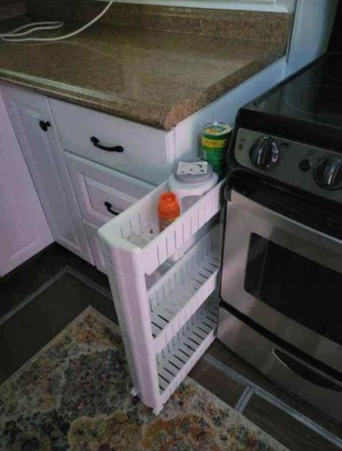 Sliding storage rack between stove and counter top